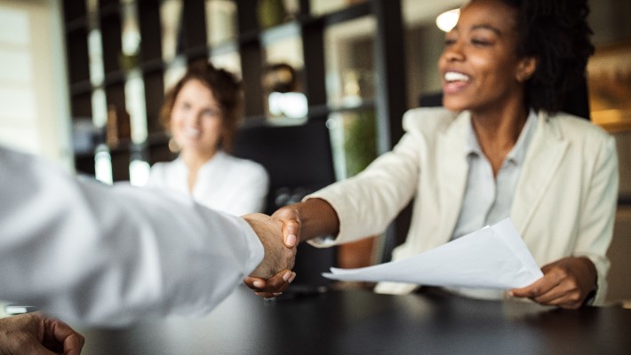 Business people shaking hands after successful meeting