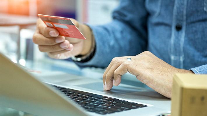 Customer using laptop and credit card for online shopping