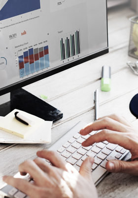 Employee working with data analytics chart using a computer at office workplace