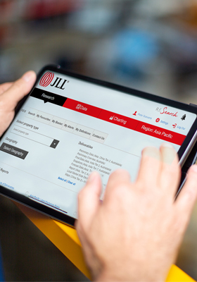 view of employee using tablet and dowload the reports/data from JLL platform