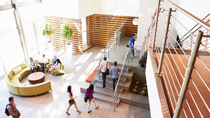 Top view of reception area of modern university building with people