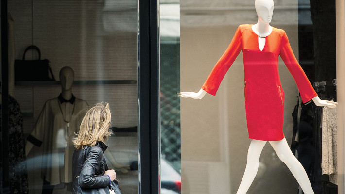 Woman looking up at a mannequin 