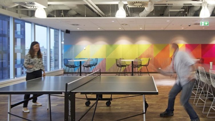 employees playing table tennis