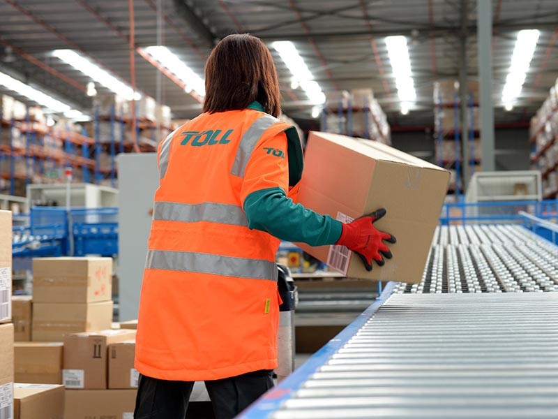 A worker picking up a parcel