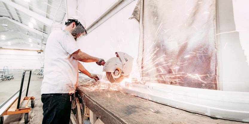 A worker working using a machine inside the industrial property