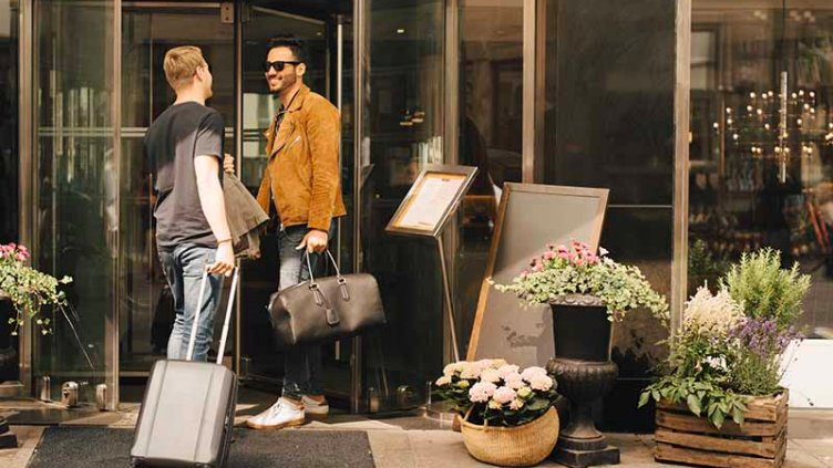 Two people entering a boutique hotel