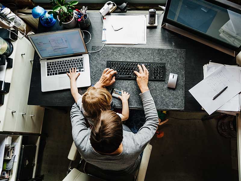 A women working from home with a child
