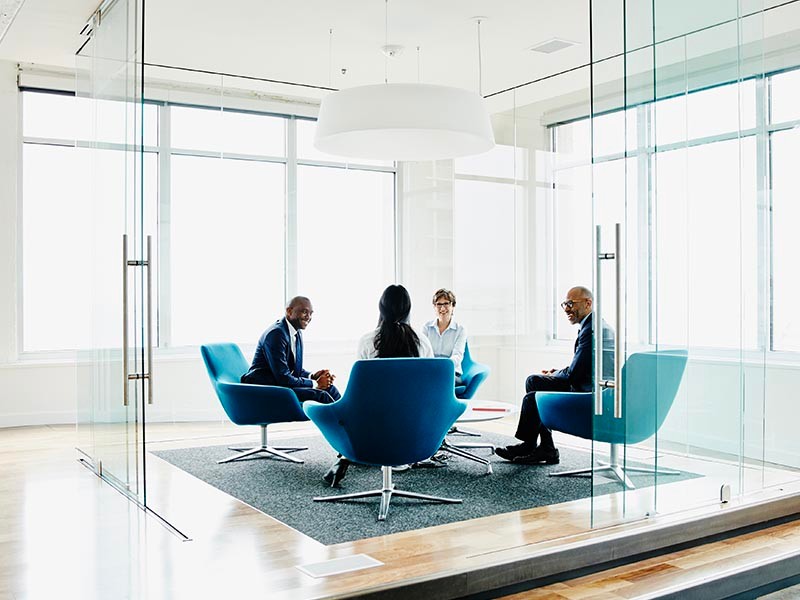 Team of businesspeople discussing project in office conference room