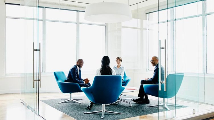 Team of businesspeople discussing project in office conference room