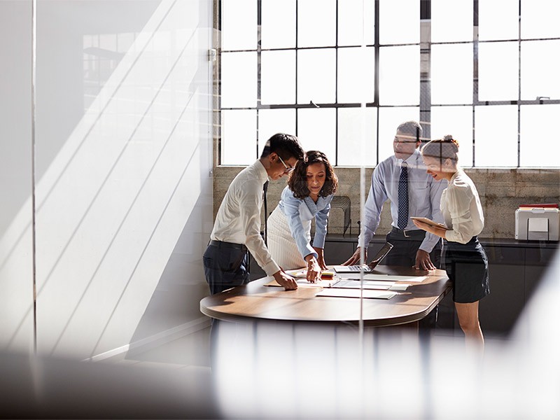 Four people discussing in a meeting room