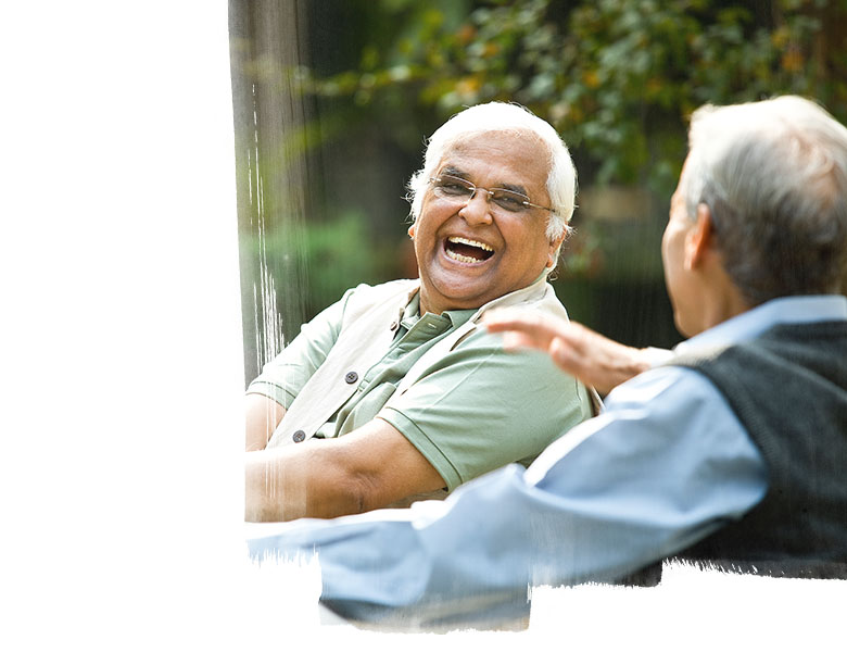 Two senior men discussing on park bench