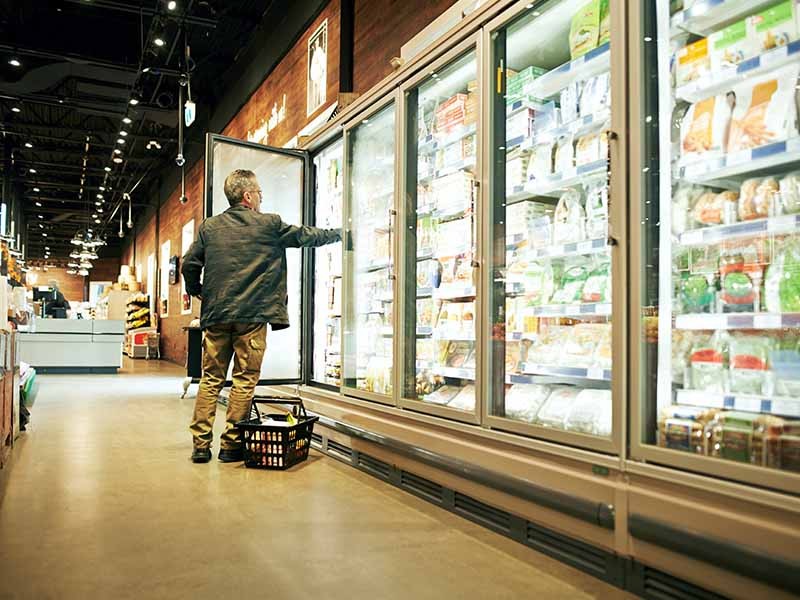 Shot of a mature man selecting frozen items in a supermarket