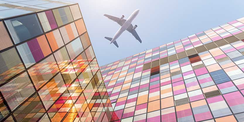 Airplane is flying above the building