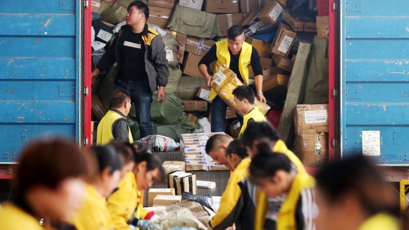 workers unloading the consignment from the loading truck