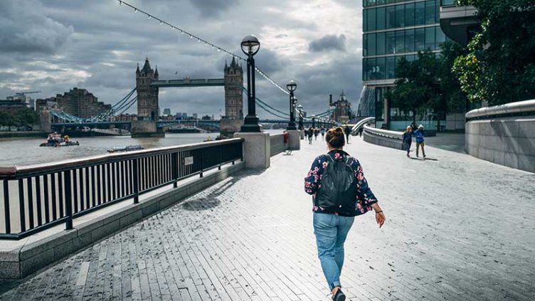 A women walking across a bridge