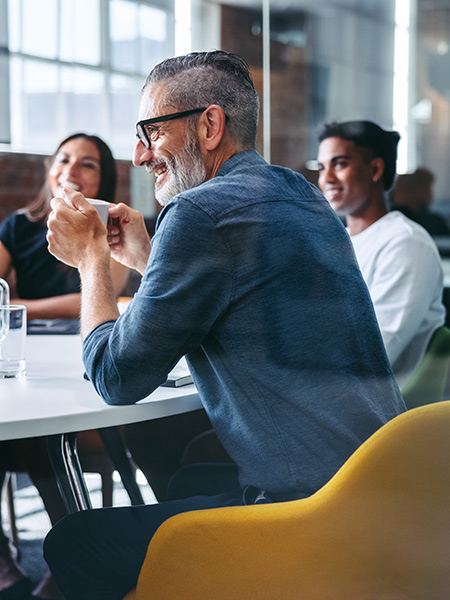 Small team meeting at table in office