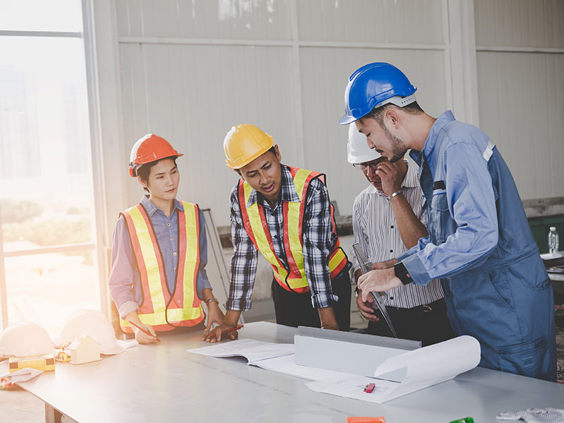 Engineers are meeting and pointing to new construction sites, Engineering tools and construction concept.