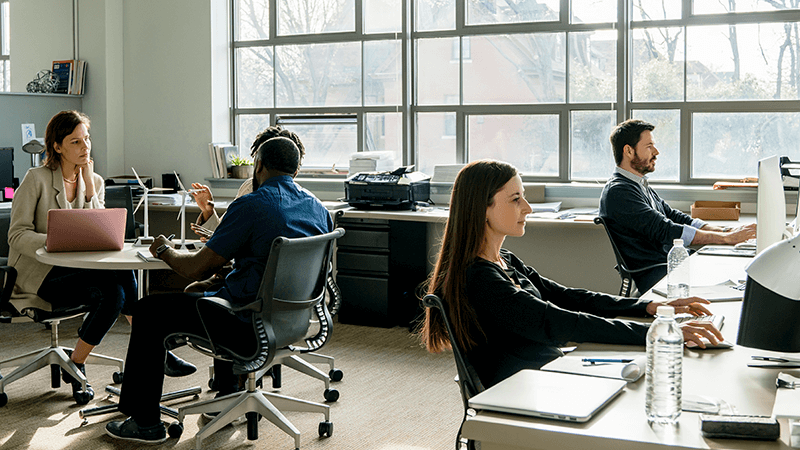 Employees working on their computer systems inside the office