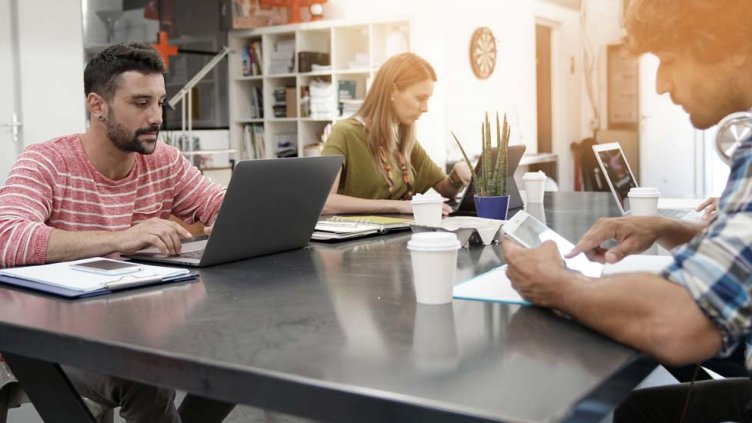 3 employees working in a coworking space