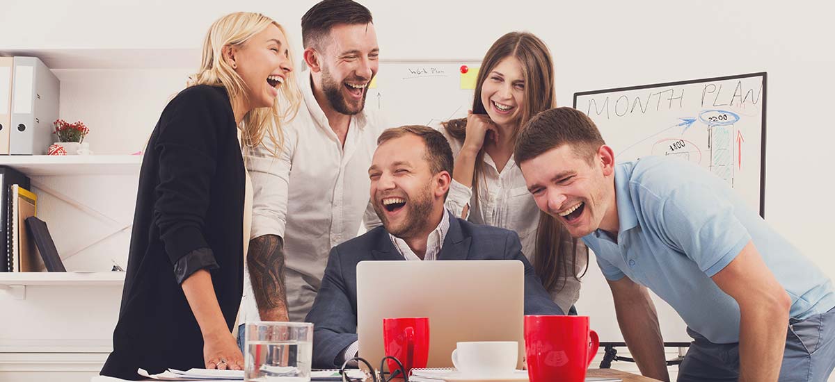 Team laughing during the meeting inside the meeting room