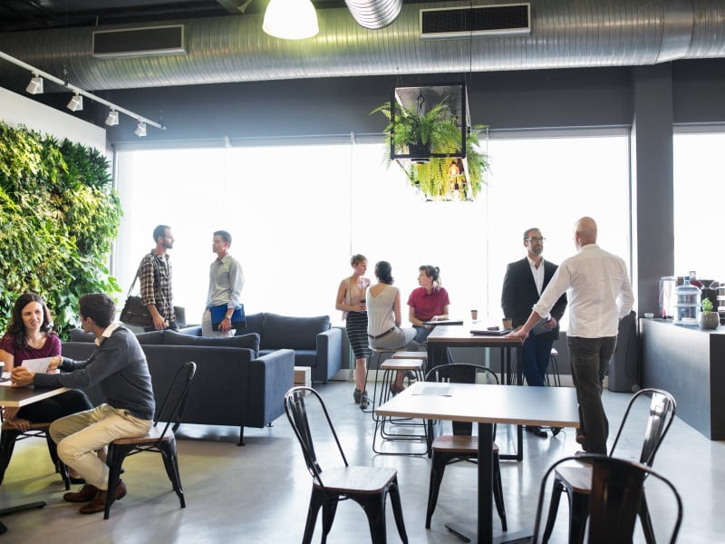 People gathered at the breakout area and discussing in groups