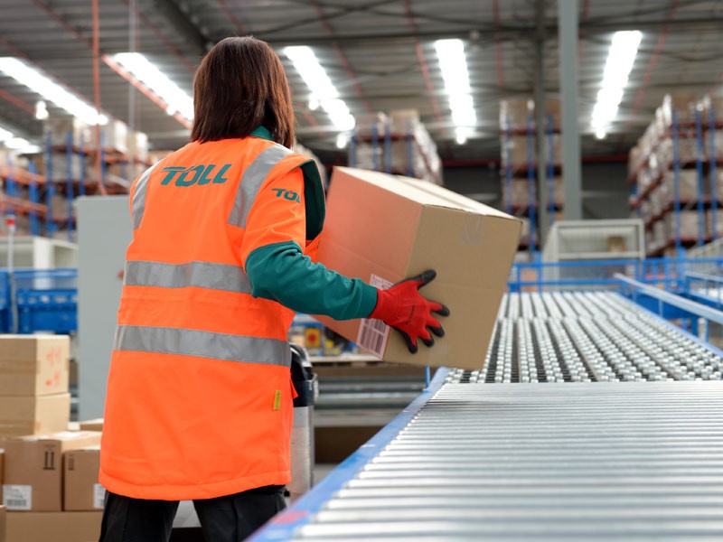Woman moving packages inside the warehouse